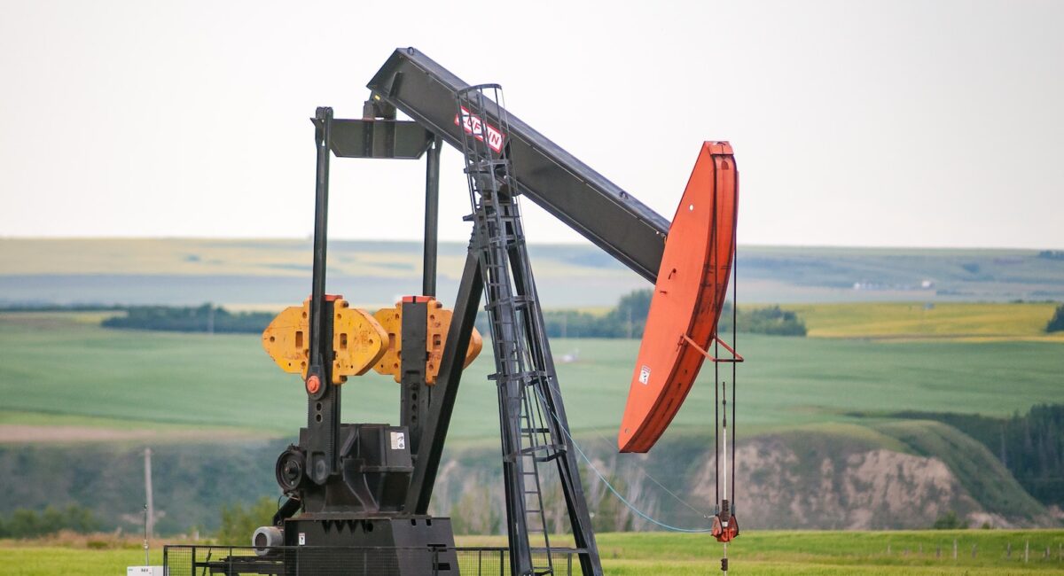 black and orange metal machine on green grass field during daytime