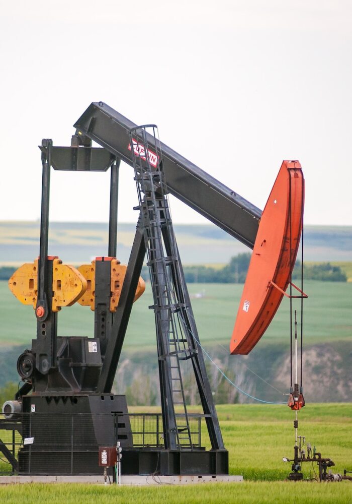 black and orange metal machine on green grass field during daytime